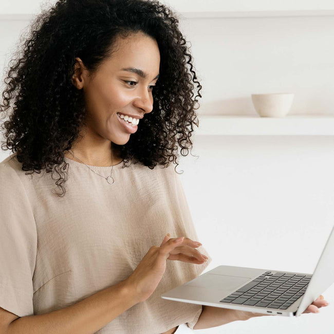 Smiling woman using a laptop