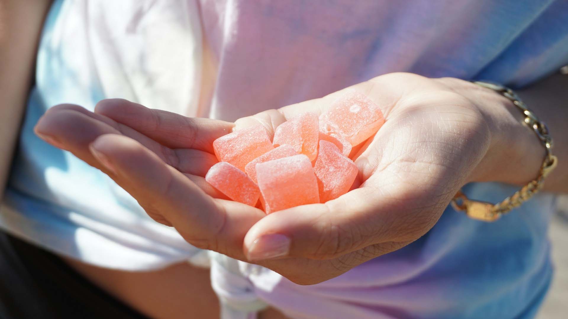 person holding orange gummies