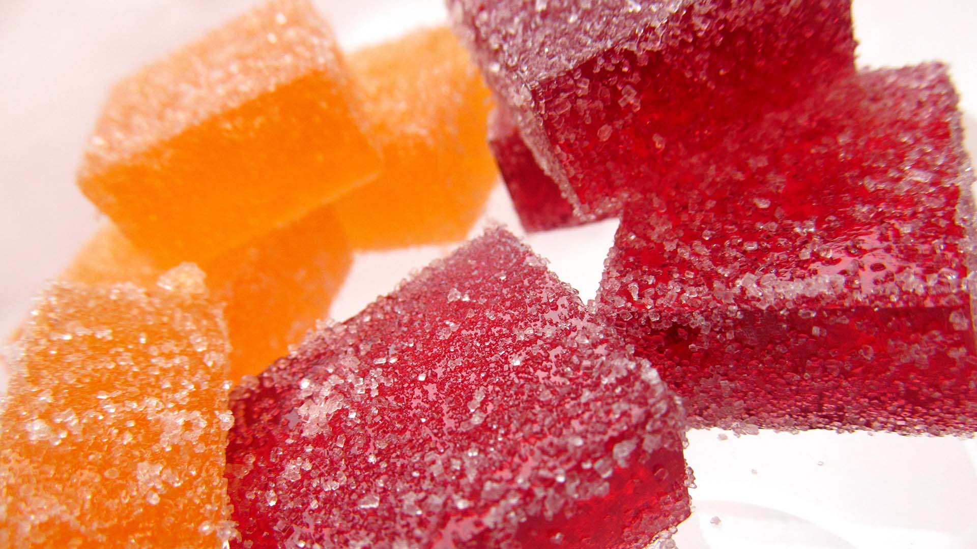 close up photography of orange and red gummies