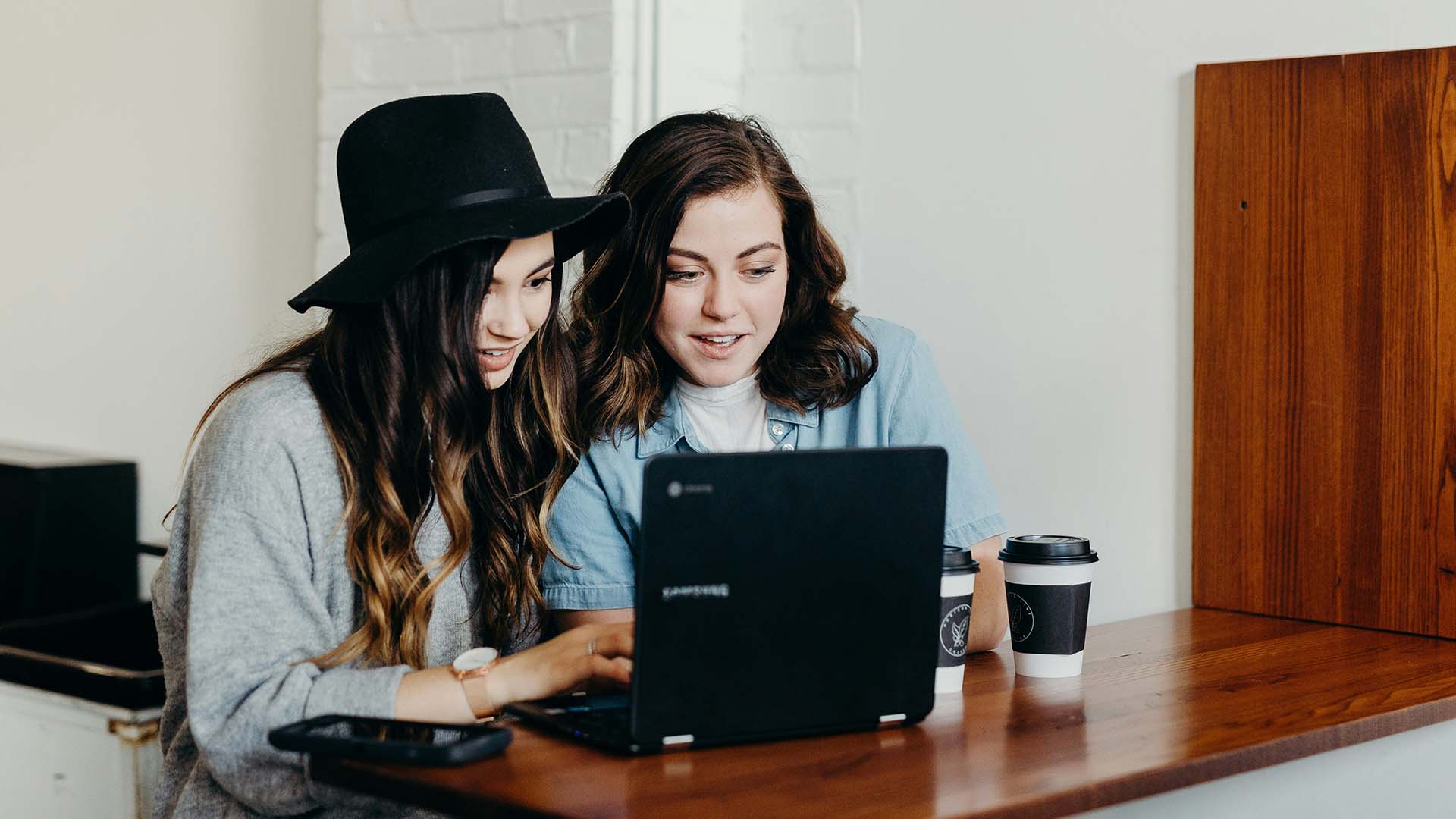 two women looking at a laptop