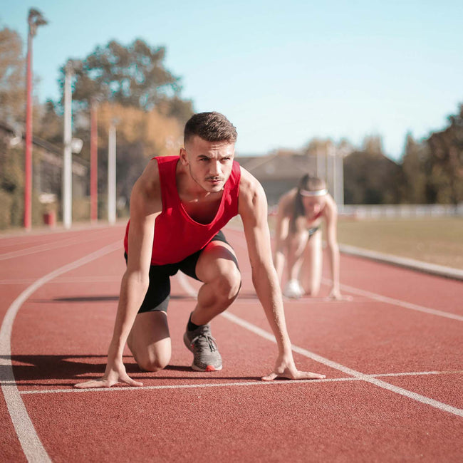 Athletes ready for a run in stadium