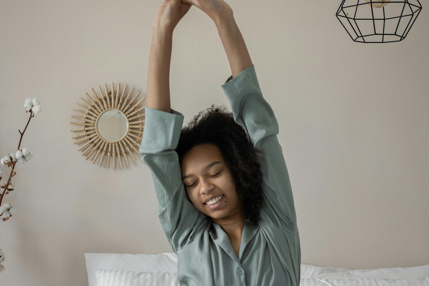 woman waking up in bed and stretching